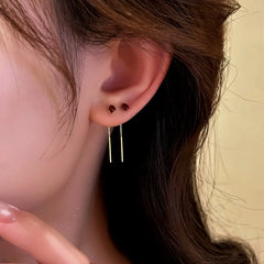 Close-up detail of the sparkling zircons and plating on the gold threader earrings