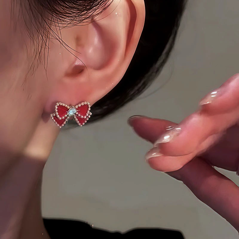 Close-up detail of the sparkling zircons and plating on the gold tassel earrings