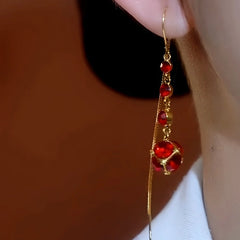 Close-up detail of the sparkling zircons and plating on the gold threader earrings