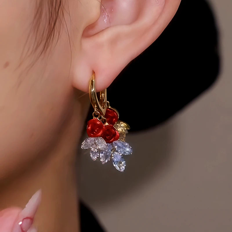 Model showcasing the dangle and style of the 14K Gold Plated Red Rose Crystal Leaf Earrings