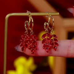 Angled view of the 14K Gold Plated Red Zircon Wheat Earrings