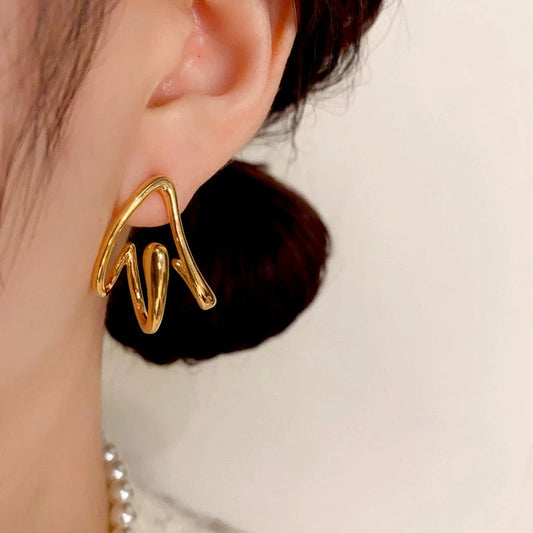 Model showcasing the dangle and style of the 14K Gold Plated Three-Dimensional Triangle Earrings