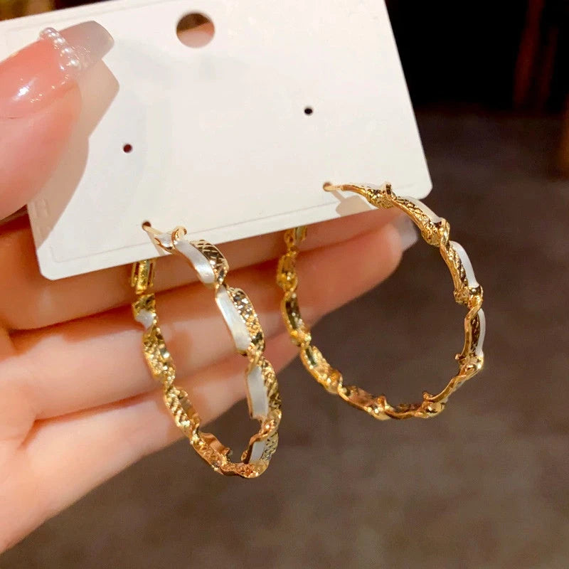 Angled view of the 14K Gold Plated Twisted Hoop Earrings