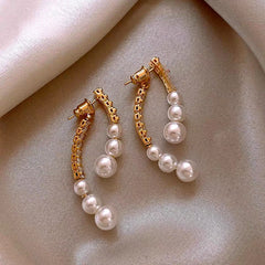 Angled view of the 14K Gold Plated Zircon Arc-Shaped Pearl Earrings