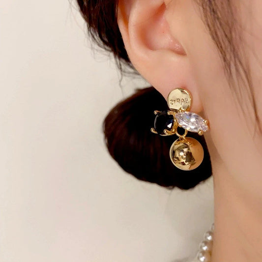 Model showcasing the dangle and style of the 14K Gold Plated Zircon Ball Earrings