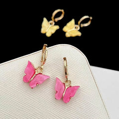 Close-up detail of the sparkling zircons and plating on the gold butterfly earrings