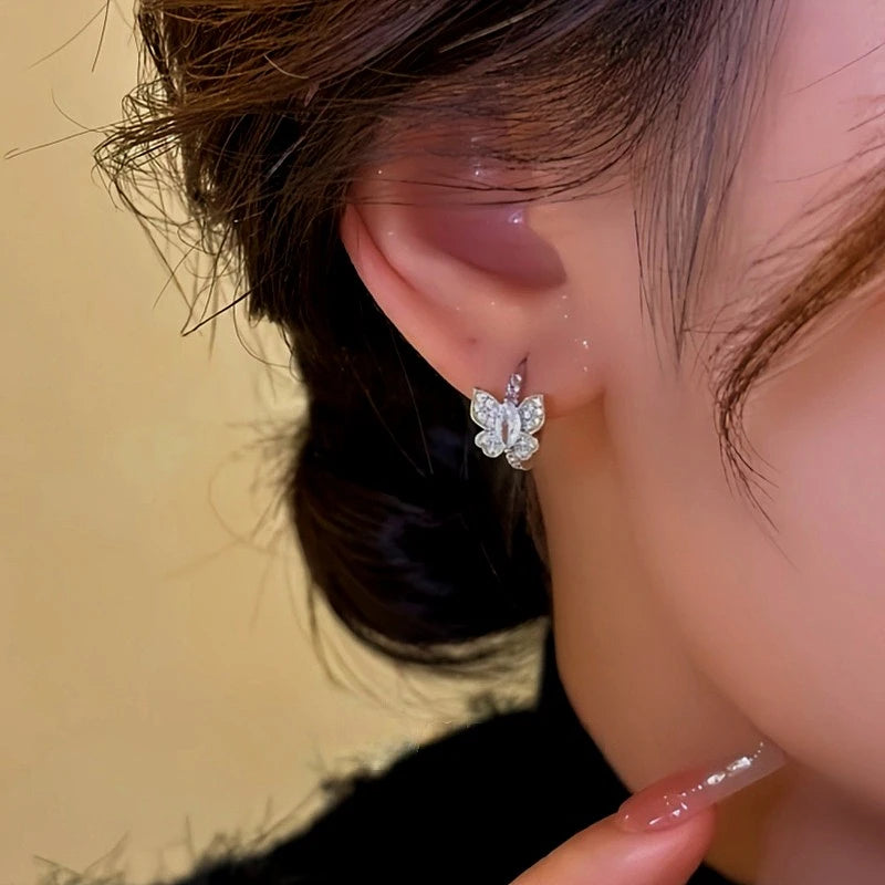 Close-up detail of the sparkling zircons and plating on the gold hoop earrings