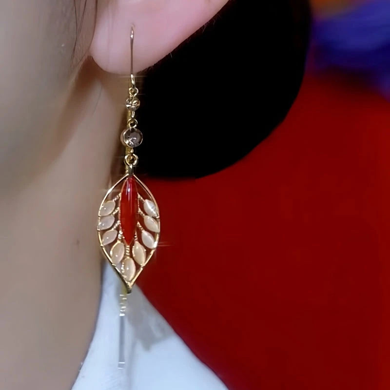 Close-up detail of the sparkling zircons and plating on the gold threader earrings