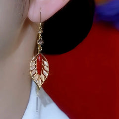 Close-up detail of the sparkling zircons and plating on the gold threader earrings