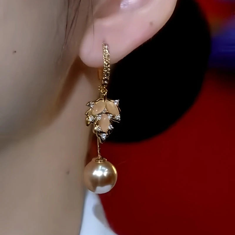 Close-up detail of the sparkling zircons and plating on the gold leaf earrings