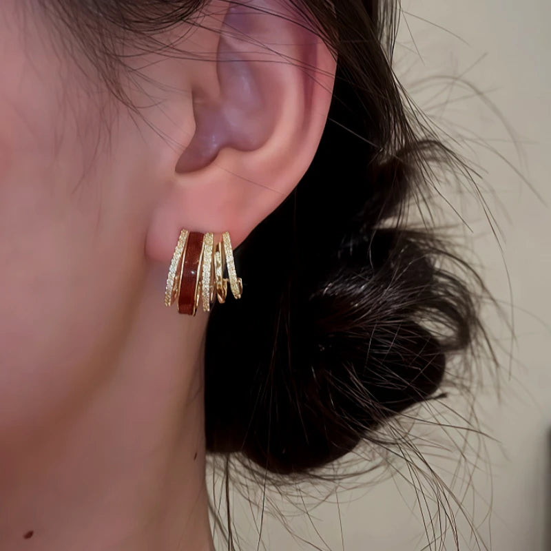 Model showcasing the dangle and style of the 14K Gold Plated Zircon Drip Glaze Multi-Layer C-Shaped Earrings