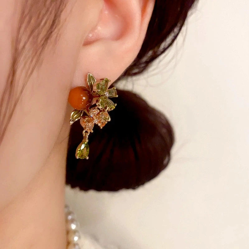 Model showcasing the dangle and style of the 14K Gold Plated Zircon Flower Bead Tassel Earrings