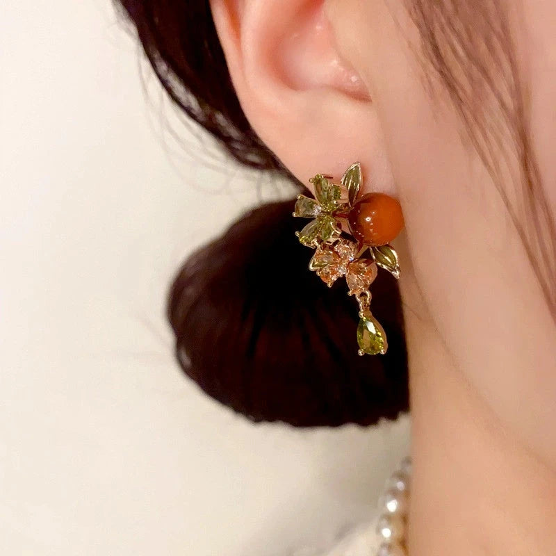 Close-up detail of the sparkling zircons and plating on the gold tassel earrings