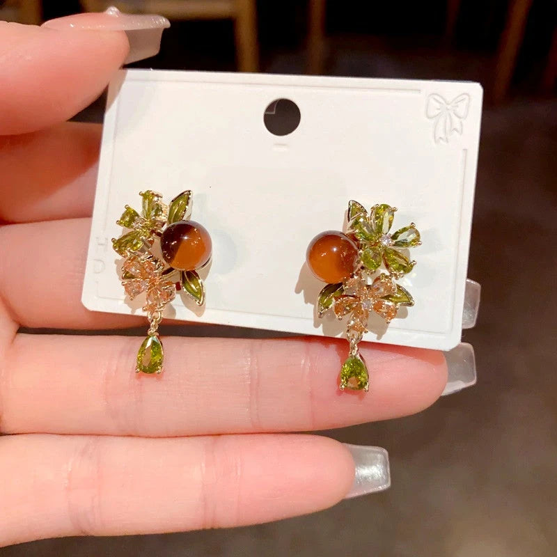 Angled view of the 14K Gold Plated Zircon Flower Bead Tassel Earrings