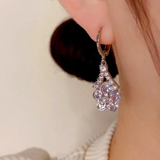 Model showcasing the dangle and style of the 14K Gold Plated Zircon Flower Earrings