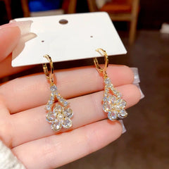 Close-up detail of the sparkling zircons and plating on the gold flower earrings