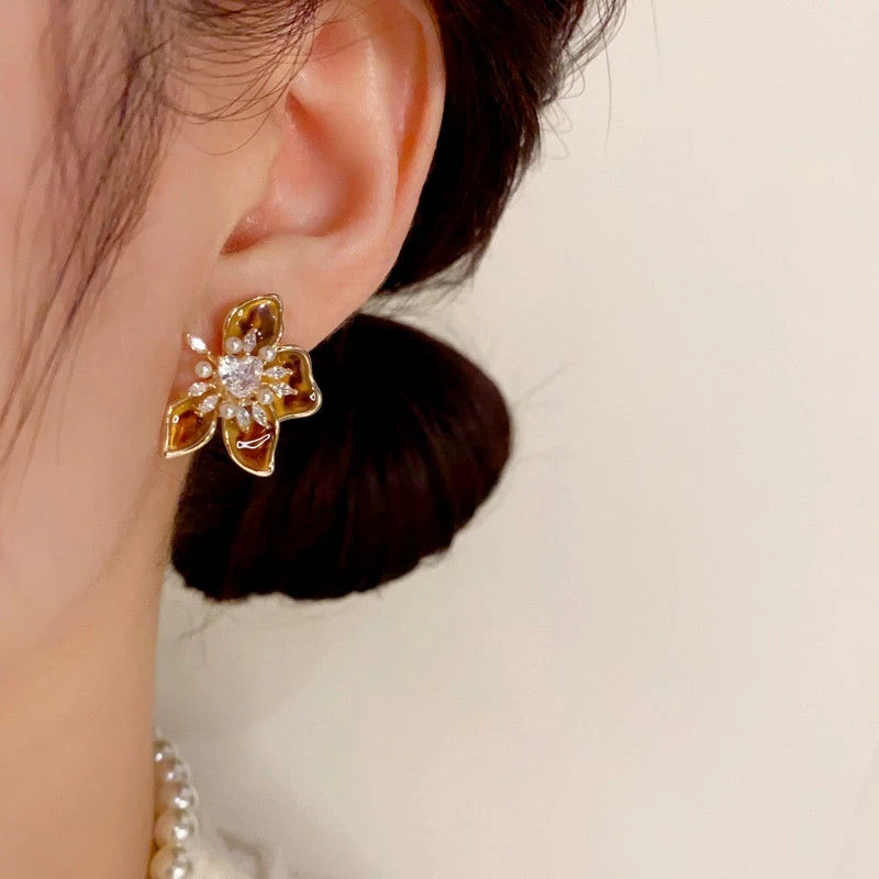 Model showcasing the dangle and style of the 14K Gold Plated Zircon Flower Stamen Earrings