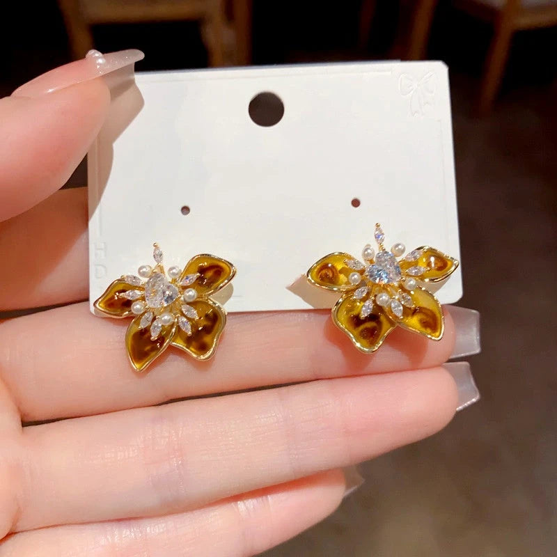Angled view of the 14K Gold Plated Zircon Flower Stamen Earrings