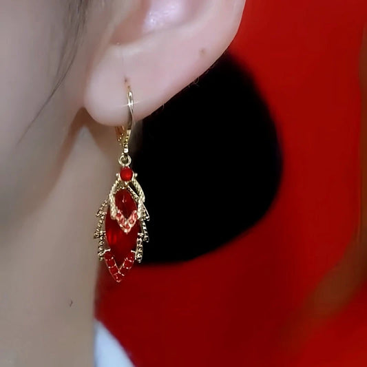 Model showcasing the dangle and style of the 14K Gold Plated Zircon Red Diamond Lead Earrings