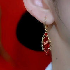 Close-up detail of the sparkling zircons and plating on the red drop earrings