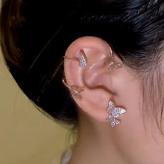 Rose gold butterfly ear cuff worn on woman's ear, rhinestone ear wrap