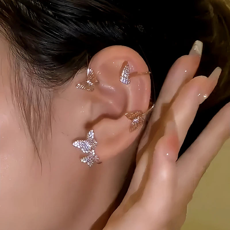 Crystal butterfly rose gold ear cuff worn on ear, women's jewelry closeup