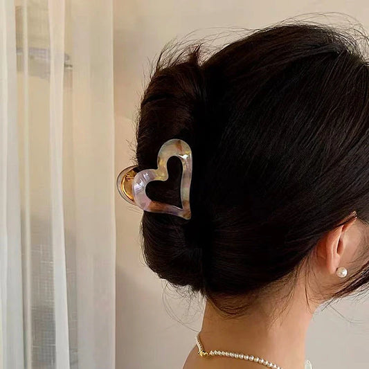 Angled view of the stylish 14K gold-plated Heart-Design Hair Clips