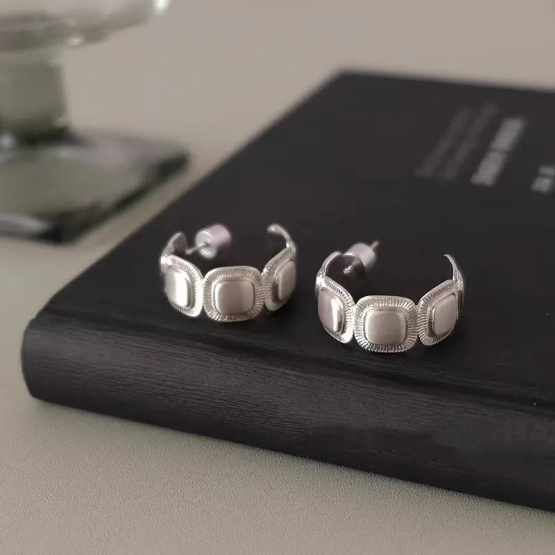 Model showcasing the dangle and style of the 18K Gold-Plated Brushed Silver C-Shaped Earrings