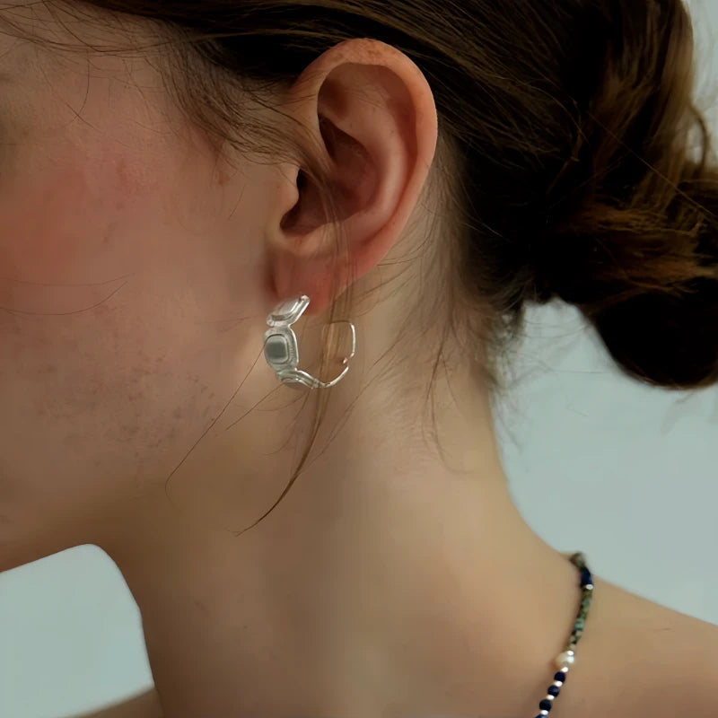 Angled view of the 18K Gold-Plated Brushed Silver C-Shaped Earrings