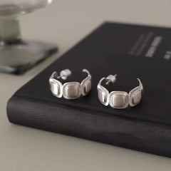 Model showcasing the dangle and style of the 18K Gold-Plated Brushed Silver C-Shaped Earrings