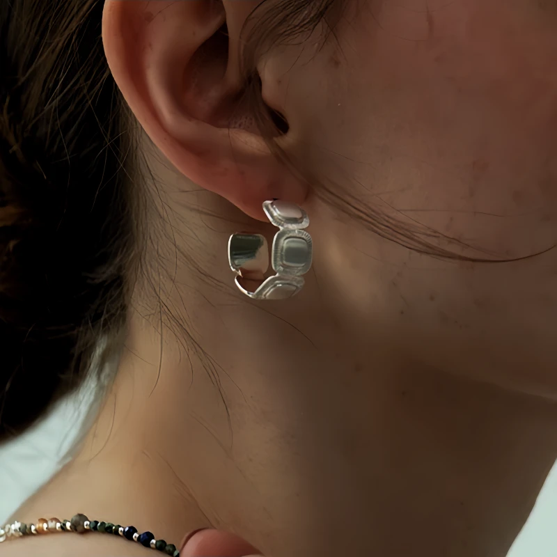 Close-up detail of the sparkling zircons and plating on the C-Shaped Earrings