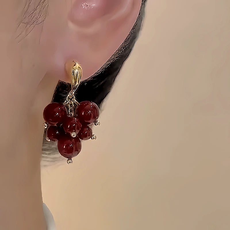Model showcasing the dangle and style of the 18K Gold-Plated Bunch Of Grape Earrings