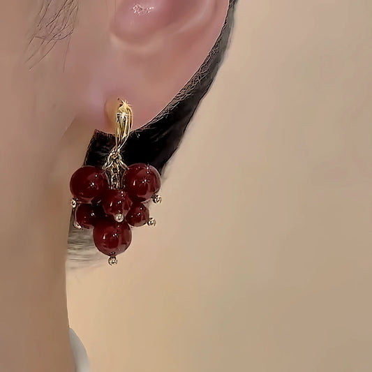 Model showcasing the dangle and style of the 18K Gold-Plated Bunch Of Grape Earrings