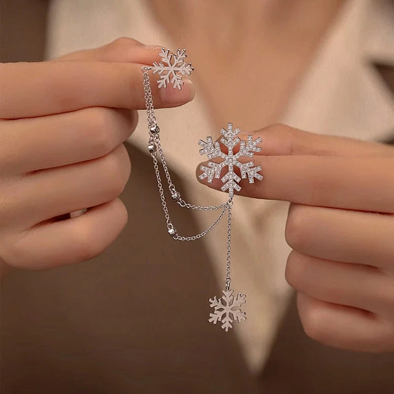 Model showcasing the dangle and style of the 18K Gold-Plated Christmas Snowflake Ear Clip Earrings