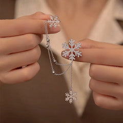 Model showcasing the dangle and style of the 18K Gold-Plated Christmas Snowflake Ear Clip Earrings