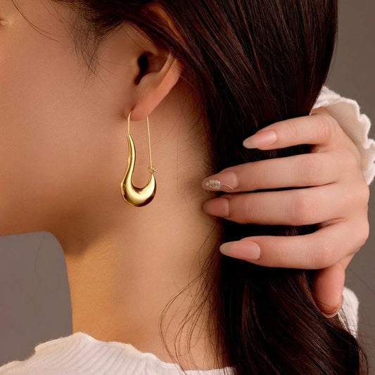 Model showcasing the dangle and style of the 18K Gold-Plated Curved Water Drop Earrings