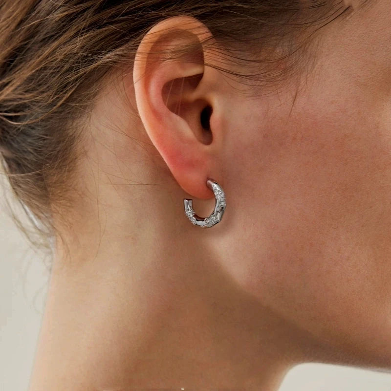 Model showcasing the dangle and style of the 18K Gold-Plated Diamond-Studded C-Shaped Earrings