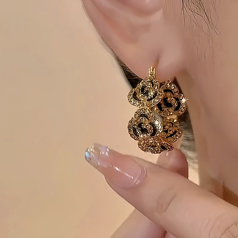 Model showcasing the dangle and style of the 18K Gold-Plated Diamond Flower Hoop Earrings