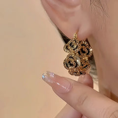 Model showcasing the dangle and style of the 18K Gold-Plated Diamond Flower Hoop Earrings