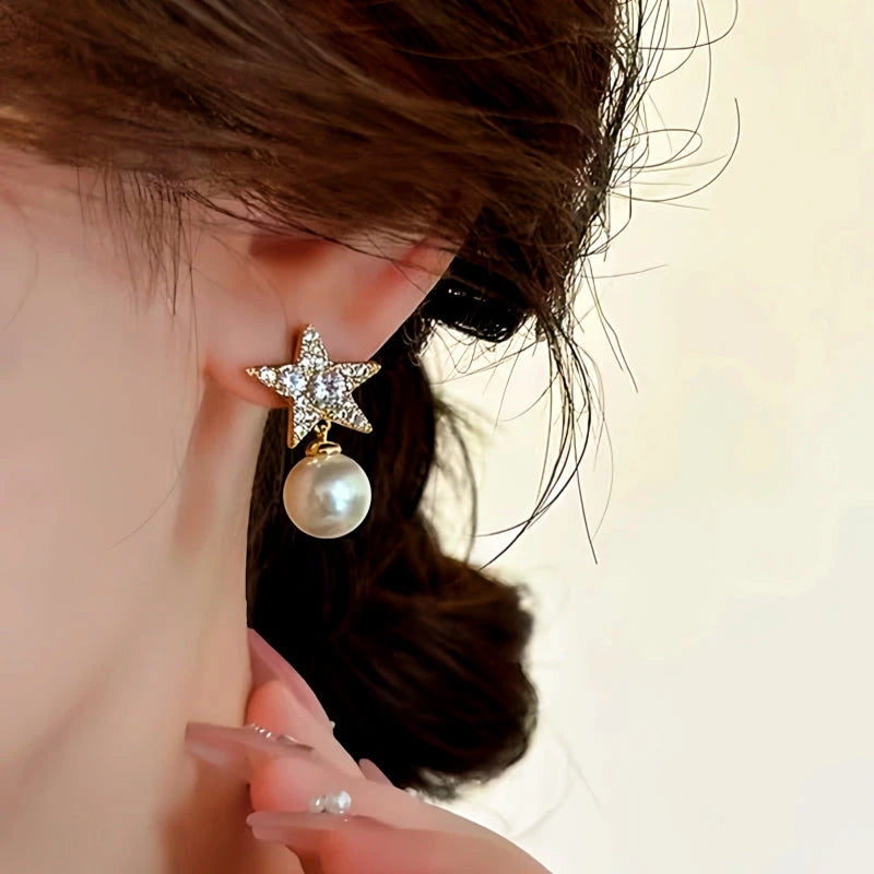 Model showcasing the dangle and style of the 18K Gold-Plated Diamond Star Pearl Earrings