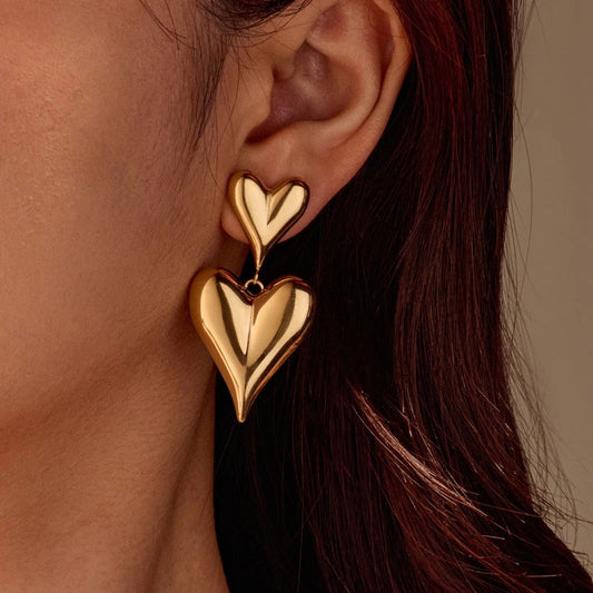 Model showcasing the dangle and style of the 18K Gold-Plated Double-Heart Earrings