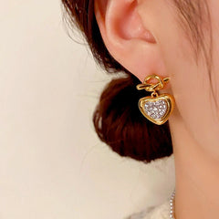 Model showcasing the dangle and style of the 18K Gold-Plated Elegant Knotted Diamond Heart Earrings