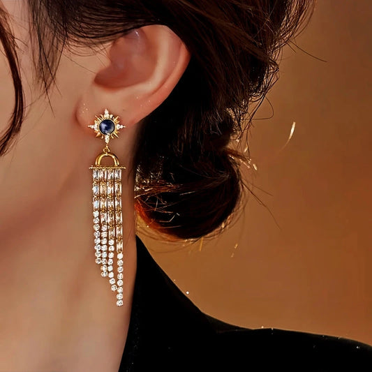 Model showcasing the dangle and style of the 18K Gold-Plated Elegant Sunflower Zircon Tassel Earrings