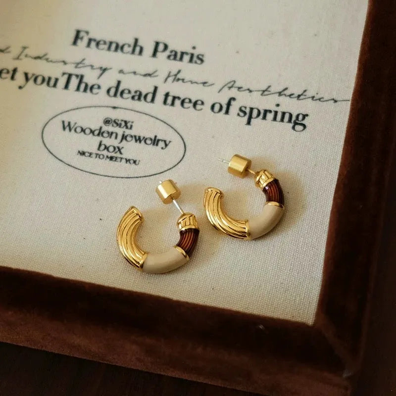 Model showcasing the dangle and style of the 18K Gold-Plated Enamel Drip Earrings