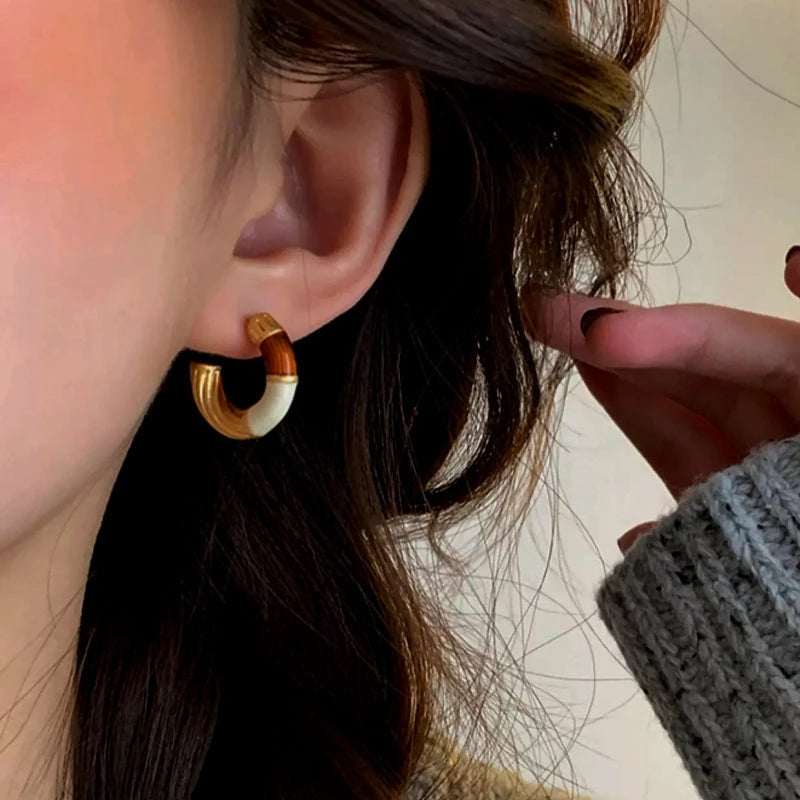 Angled view of the 18K Gold-Plated Enamel Drip Earrings