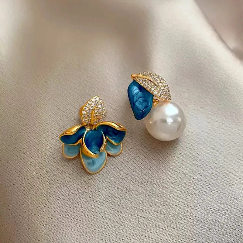 Model showcasing the dangle and style of the 18K Gold-Plated Enamel Drip Flower Earrings