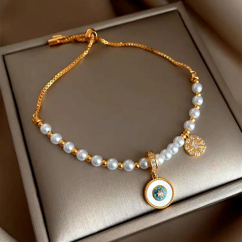 Model wearing the 18K Gold-Plated Exquisite Eight-Pointed Star Zircon Pearl Bracelet to highlight its design on the wrist