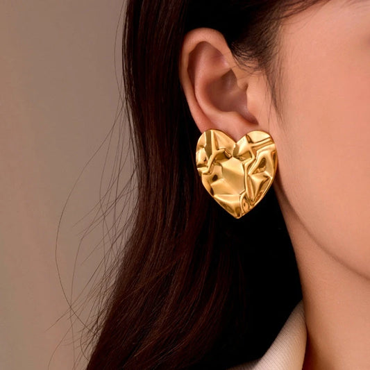 Model showcasing the dangle and style of the 18K Gold-Plated Heart-Design Earrings