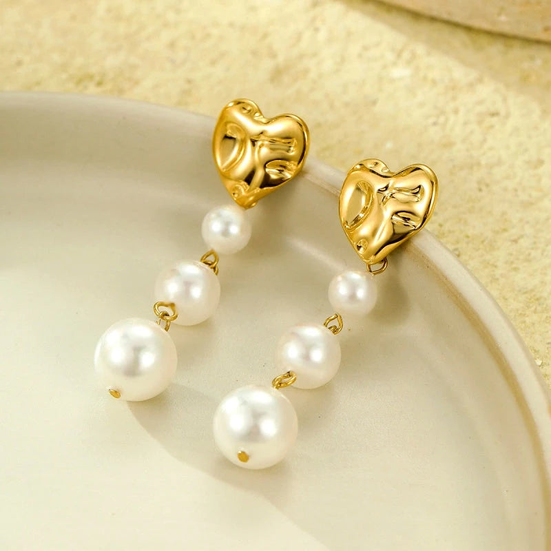 Close-up detail of the sparkling zircons and plating on the Heart Pearl Earrings