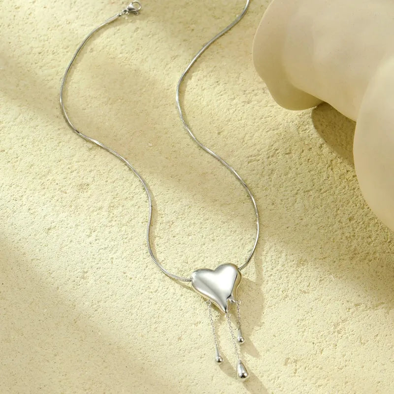 Detailed view of the 18K Gold-Plated Heart Tassel Necklace chain and pendant